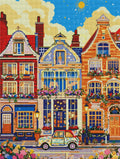 Pixel-Vorschau eines Diamond Painting Bildes mit farbenfrohen Hausfassaden und einem kleinen Retro-Auto.
