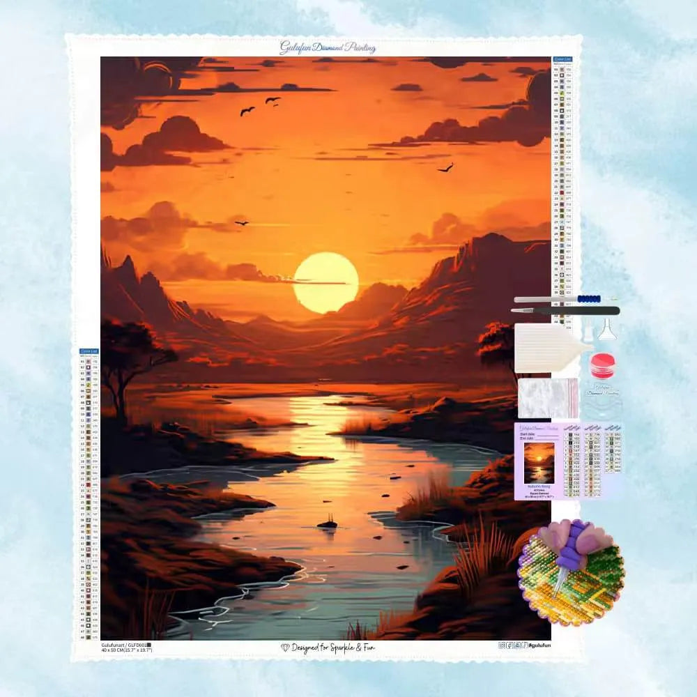 Diamond Painting Motiv eines leuchtenden Sonnenuntergangs über einer idyllischen Landschaft mit Fluss und Bergen