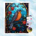 5D Diamond Painting Motiv: Ein Singvogel auf einem Zweig mit roten Blumen im klassischen Buntglas- und Mosaik-Design vor blauem Hintergrund.